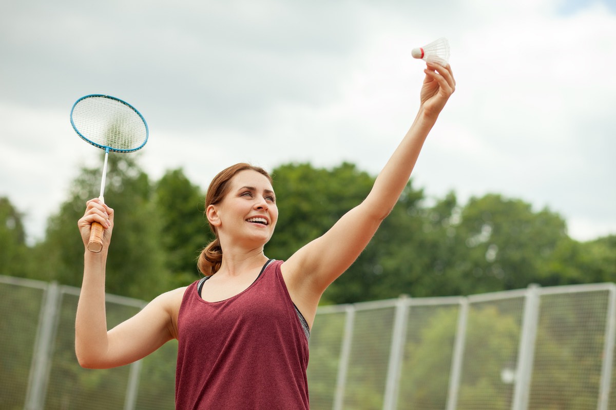 Attractive woman playing badminton