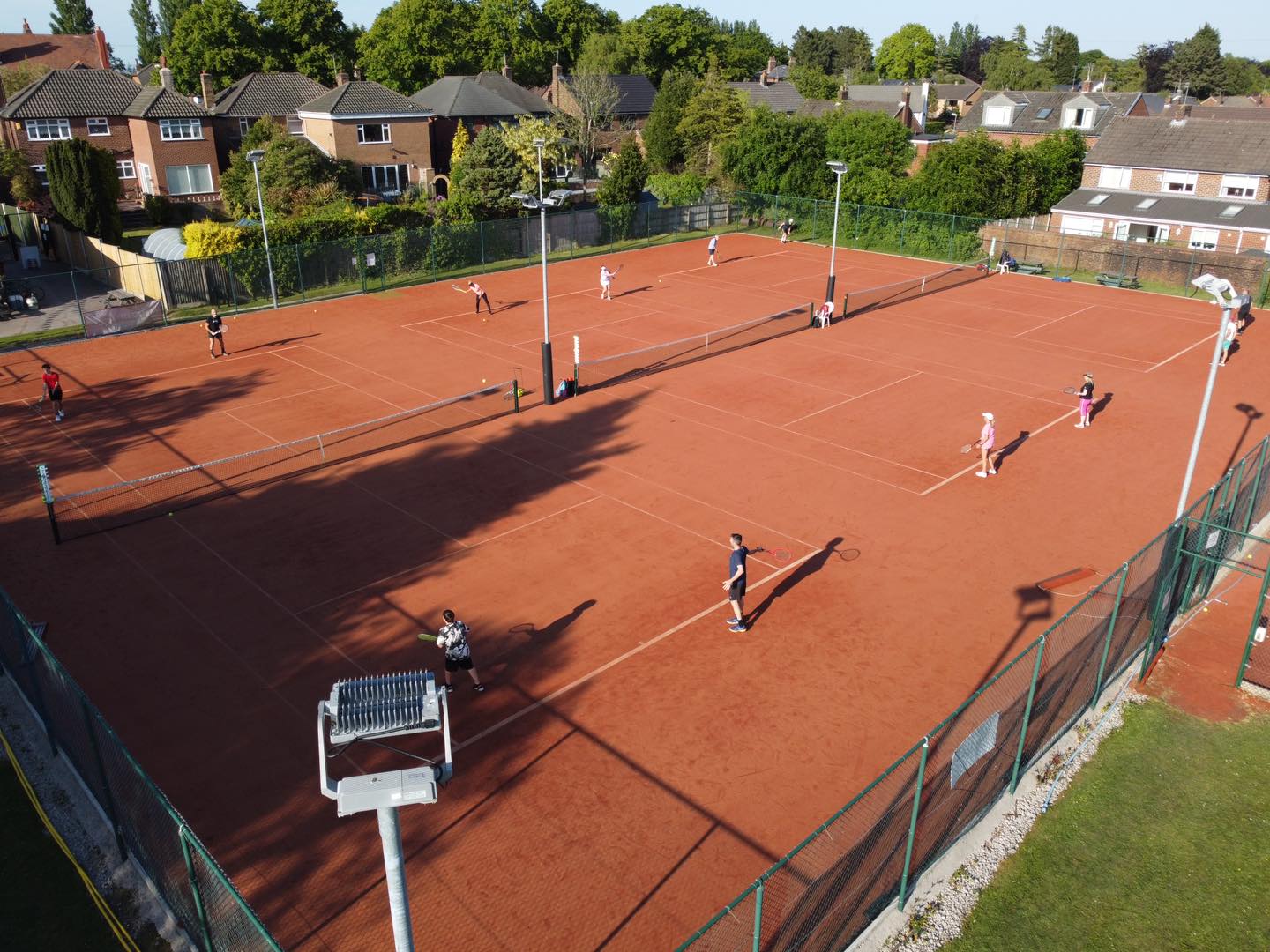 Aerial view of Eccleston Park Tennis Club showing multiple clay courts during tournament play