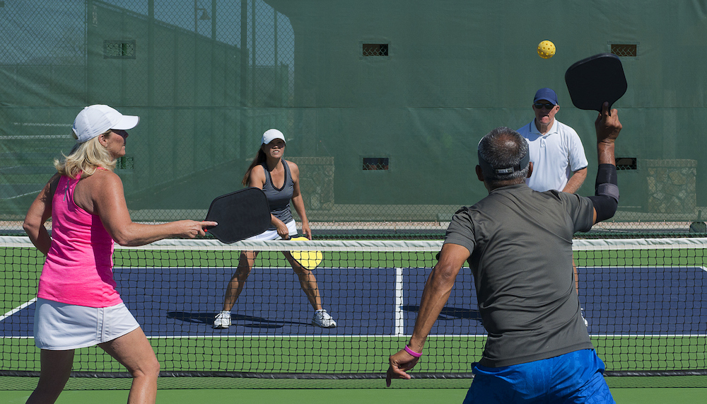 4 people playing a game of Pickleball