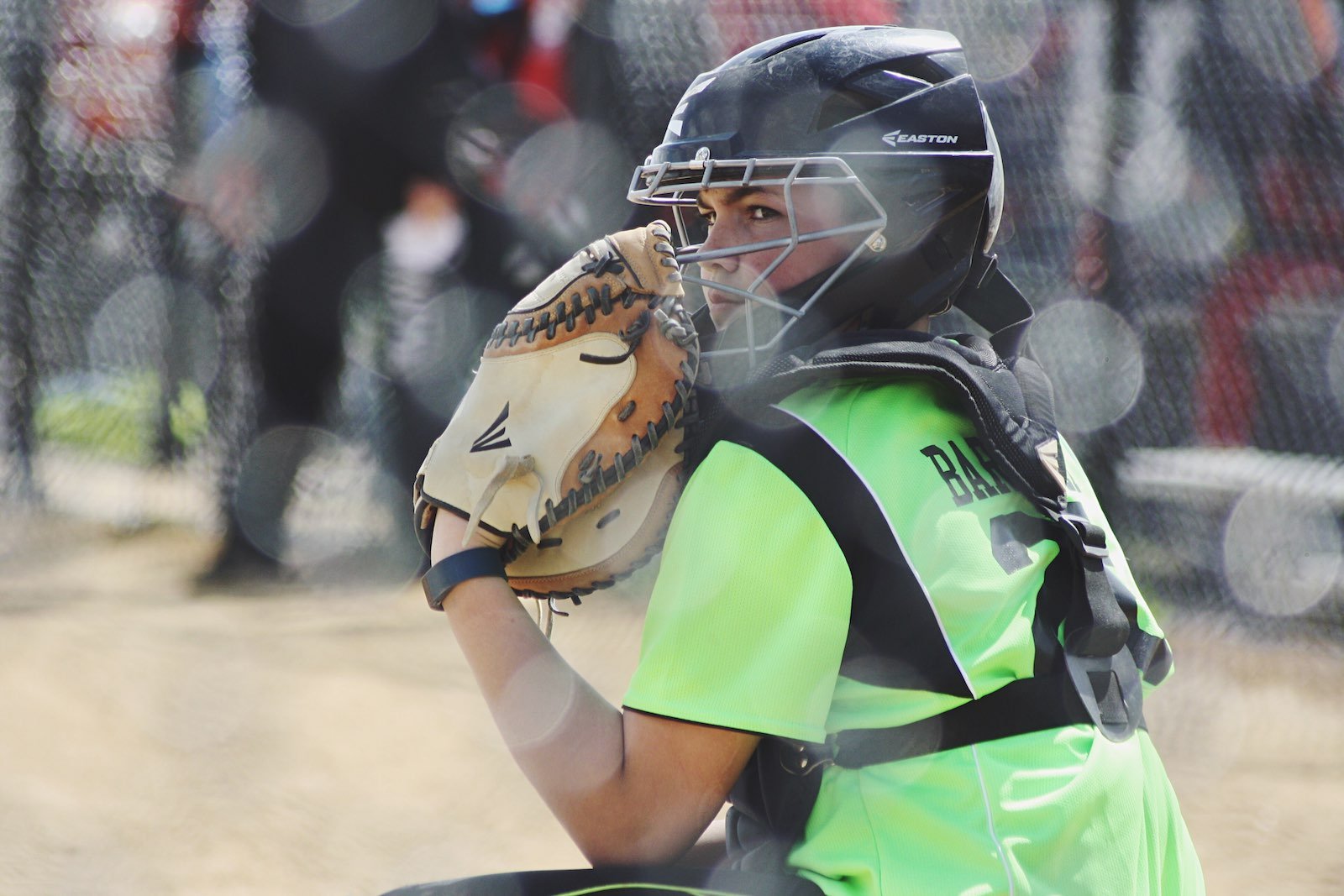 A softball player wearing a helmet