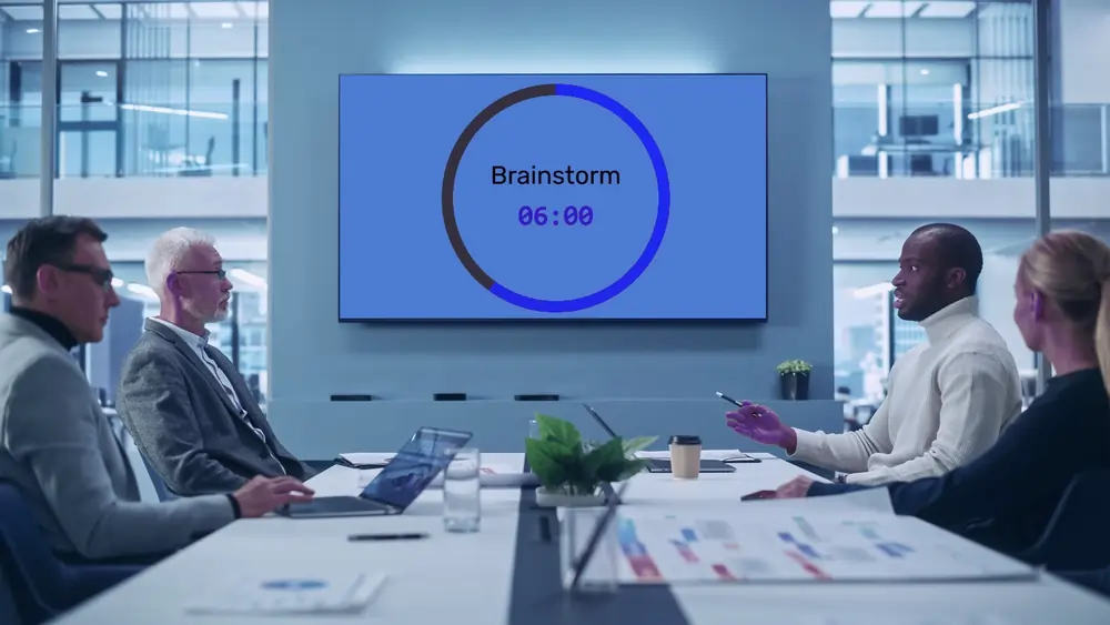 Feature screenshot: Office meeting with a timer running on a screen